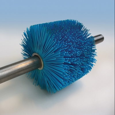 Conveyor cleaning outlet brush